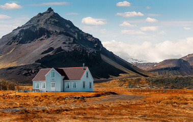 Typical Icelandic landscape with houses against mountains during sunset. famous Arnarstapi village at sunset. Best famouse travel and holiday locations Saefellsnes peninsula. Iceland