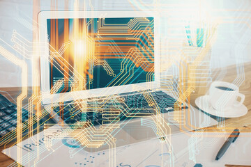 Double exposure of desktop with computer and world map hologram. International data network concept.