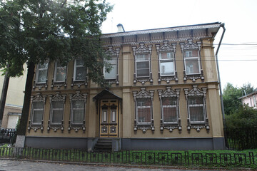 Wooden house with carved windows on Pushkin Street, 11, Yaroslavl city, Russia. Russian style in...