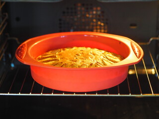 Apple pie baking in the oven. Process of preparation of apple pie. Homemade. Soft focus, close up.