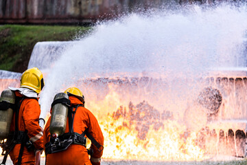 Firefighters spraying down fire flame from oil tanker truck accident