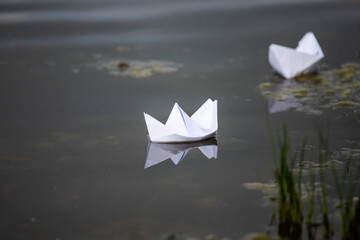 origami ships on the water