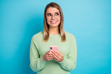 Close-up portrait of her she nice-looking attractive lovely cheerful cheery girl using cell creating new post media multimedia app 5g isolated over bright vivid shine vibrant blue color background