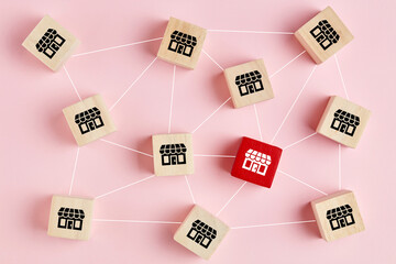 Franchise and business growth concept. Wooden cubes with store icons linked to each other with...