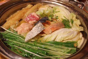 Shabu-shabu is a Japanese nabemono hotpot dish of thinly sliced meat and vegetables boiled in water in Osaka, Japan