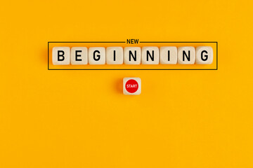 Starting a new beginning concept. The word new beginning on wooden cubes with a start button.
