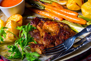 grilled neck chops with caramelized vegetables.