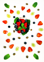 composition with berries and berry mixture in a crystal glass with strawberries, blueberries, blueberries and mint close-up