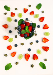 Naklejka na ściany i meble composition with berries and berry mixture in a crystal glass with strawberries, blueberries, blueberries and mint close-up