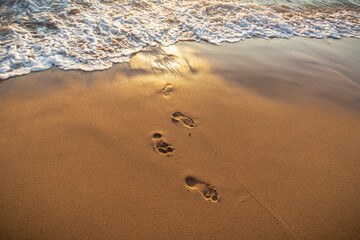 Footprints in the sand to be erased by the sea, sintra, portugal