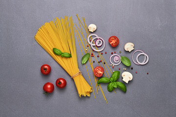 Tomato, basil, spices, champignons, onion, pasta. Vegan food, creative composition on marble. Fresh basil, herb, cherry tomatoes layout, cooking Italian pasta concept, top view.