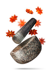 Granite mortar and anise stars falling isolated on white background