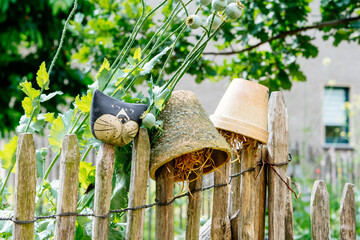 Garden decoration with ceramic cat and pottery backyard fence fun and joyful with flower pot for fun detail