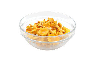 Chanterelle mushrooms in a glass plate on a white background.