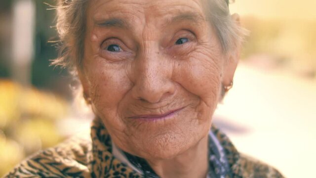 Active retirement faces concept. Portrait of happy smiling 92 year old senior woman outdoors. Closeup, 4K UHD, slow motion.