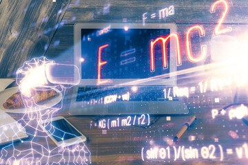 Desktop computer background and formula hologram writing. Double exposure. Education concept.