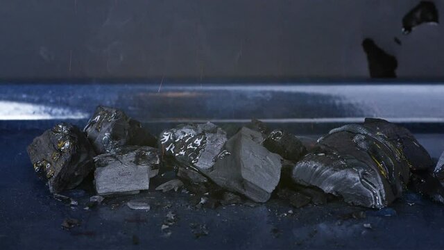 Close-up large coals are burning, tongues of flame. Embers are burning in the oven, cooking.