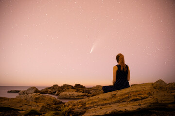 woman looking at neowise comet at night