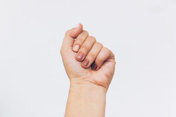 Female fist protesting on white background. Female hand raised up with different nails colors, skin and race diversity. Women rights concept. Stop racism