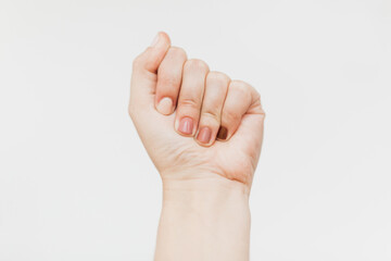 Female fist protesting on white background. Female hand raised up with different nails colors, skin and race diversity. Women rights concept. Stop racism
