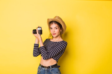 Woman photographer beauty caucasian brunette young girl on yellow background 