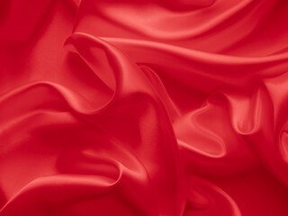 Beautiful elegant wavy red satin silk luxury cloth fabric texture with red background design. Card or banner.