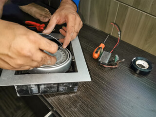 an electrician repair a kitchen light