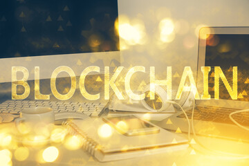 Multi exposure of blockchain theme hologram and table with computer background. Concept of bitcoin...