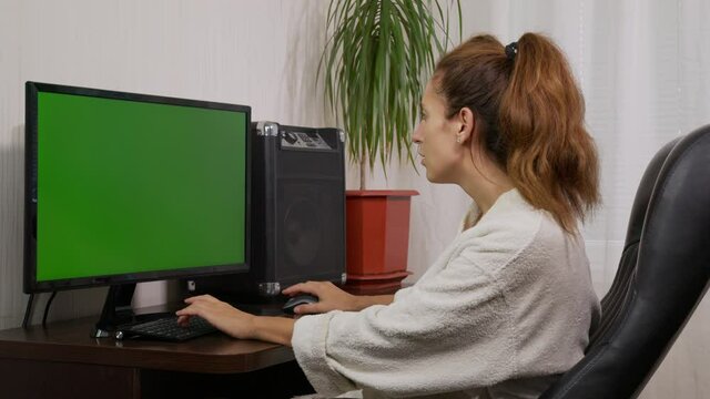 Shot of woman typing on laptop keyboard with green screen, Working from home, Home office person using laptop computer with chroma key green screen.