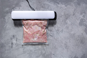 Vacuum packing of meat for long-term storage. Turkey fillet in a vacuum bag.