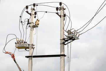 Two concrete electricity power pole connected with electric wires cable line.