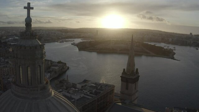 Scenic drone panorama in valletta malta with church cathedral during sunset 