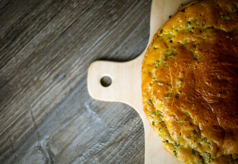 Fresh delicious pie lies on a cutting board on the table. Hot baked goods