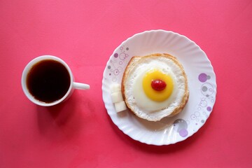 Homemade Fried Egg on burger and cup of Coffee for Breakfast,cherry  top view, 