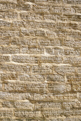 stone wall of roughly cut limestone blocks of different sizes as a background