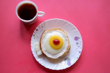 Homemade Fried Egg on burger and cup of Coffee for Breakfast,cherry  top view, 