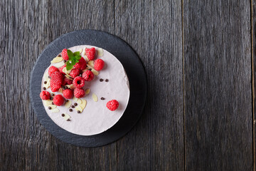 raspberry mousse cake on a slate black plate