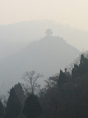 A beautiful hazy image of a pavilion on Mount Li in winter season, a mountain located in the northeast of Xian in Shaanxi Province, China, Popularly for its shine like a beacon in the evening sunlight