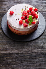 raspberry mousse cake on a slate black plate