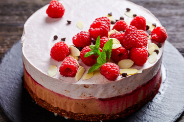 raspberry mousse cake on a slate black plate