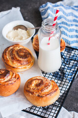 Homemade yeasty buns with cottage cheese filling with milk.