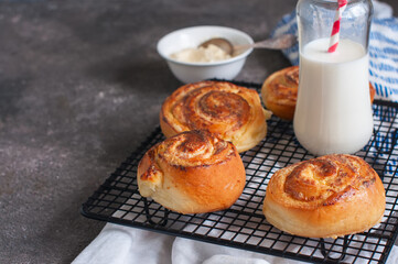 Homemade yeasty buns with cottage cheese filling with milk.
