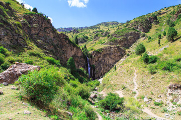 Kegeti waterfall. Background for tourism and travel. Summer landscape. Kegeti Gorge, Kyrgyzstan.