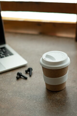 keep cup of coffee with a silicone lid on the table. Isolated