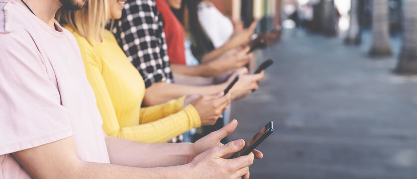Group friends using mobile smartphones outdoor - Millennial young people addicted to new technology trends apps - Youth social generation lifestyle concept