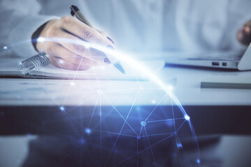 Social network theme hologram over hands taking notes background. Concept of global international people connect. Double exposure