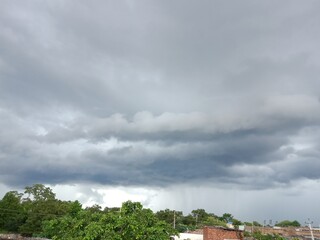 Fototapeta na wymiar Cloud before rain Raining on one side and clouds on other side