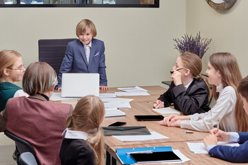 Obraz premium Young businessmen at a board meeting in the office. Children are businessmen.