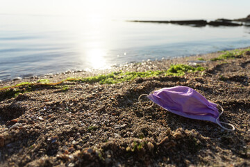 Wasted Medical Mask Lying On Polluted Beach Outdoors, Free Space