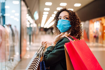Fototapeta na wymiar Young woman in medical face mask after shopping during coronavirus pandemic. Covid-2019.